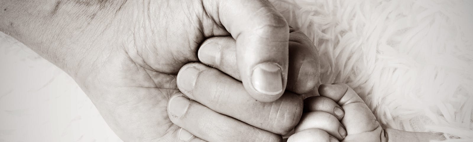 A father and a young son holding a fist bump.