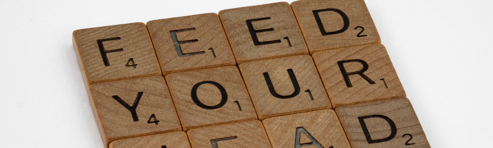 Scrabble pieces arranged as a block spelling the words, “feed your head”