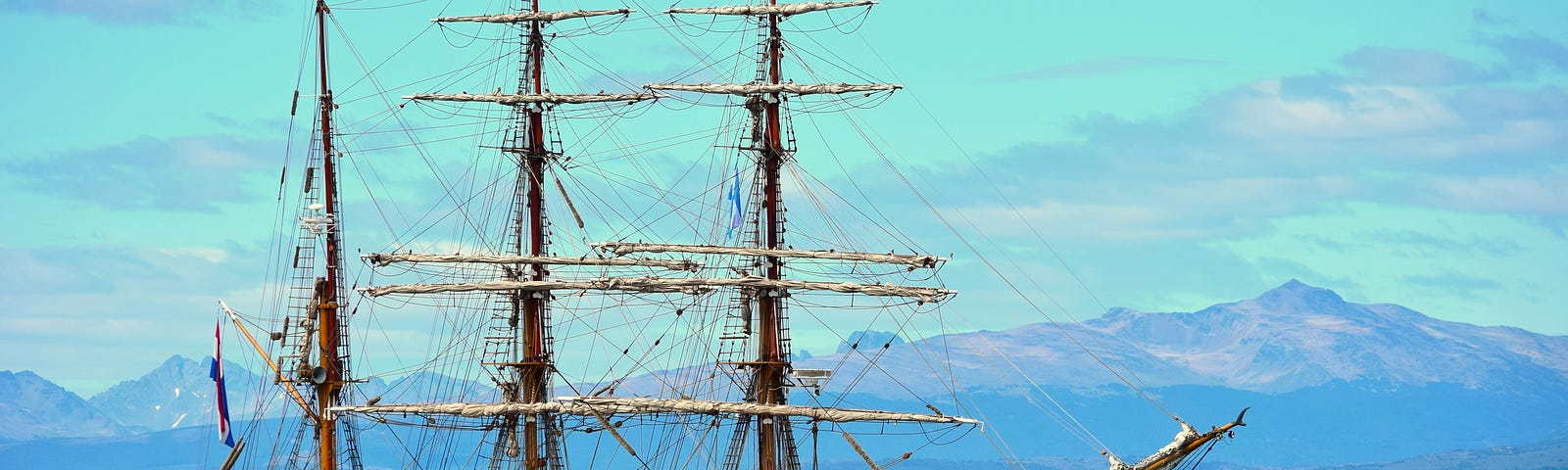 Picture of a sailing ship on a calm sea via Alt text on Medium