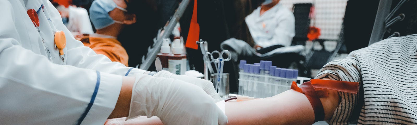 person sitting in a chair waiting for IV to be started