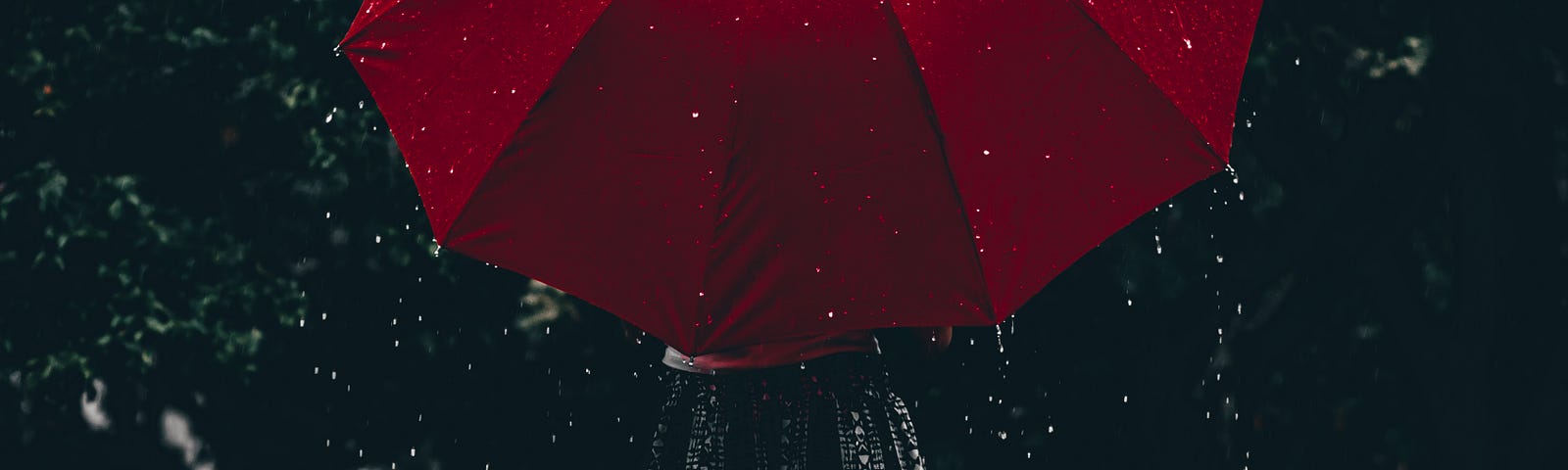 a person holding a red umbrella