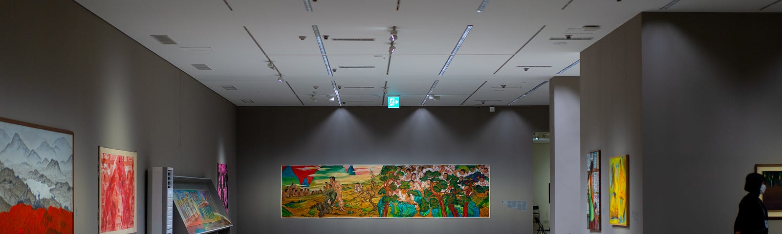 A modern art gallery with large, colourful paintings on walls