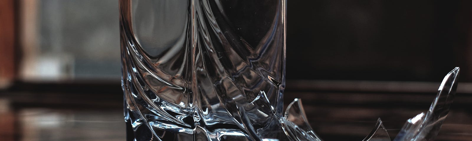 A water glass broken in two pieces.