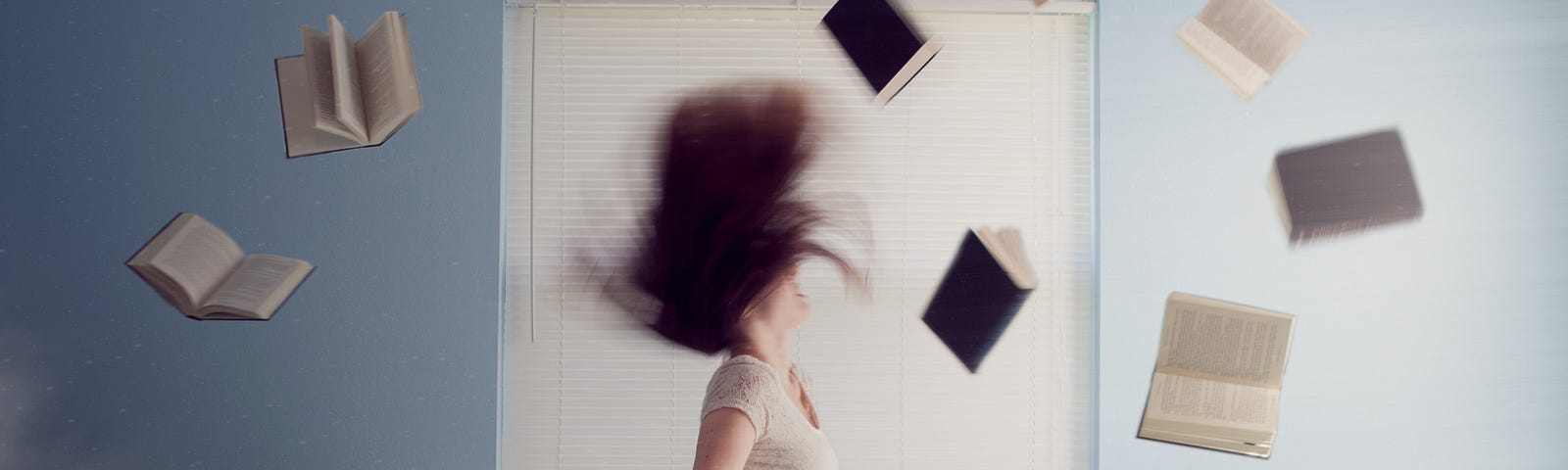 a woman sits on her bed surrounded by books some of which are dancing in the air around her