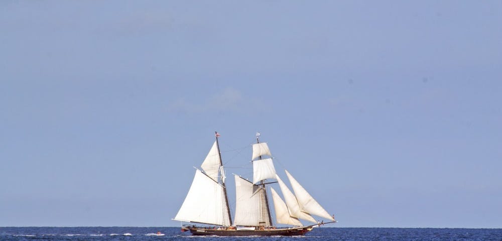 A renaissance era sailboat sailing majestically on the blue ocean