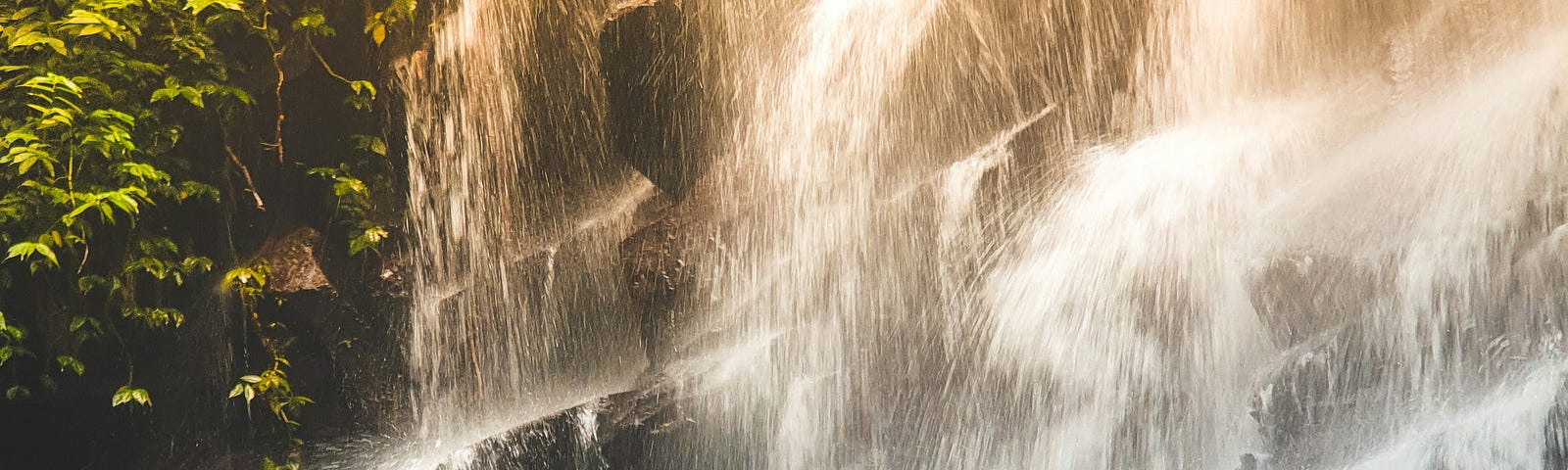 Woman meditating near waterfalls.