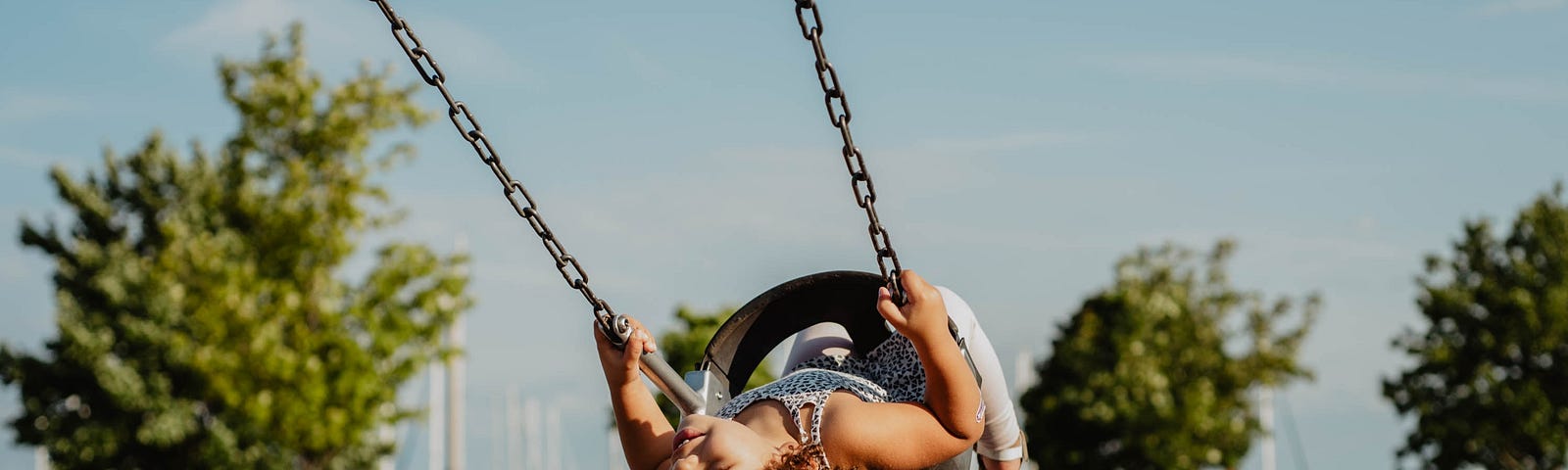 This photo shows a child on a swing.