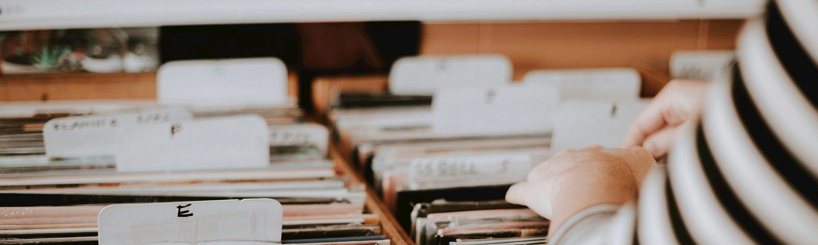 woman going through file of music (records)