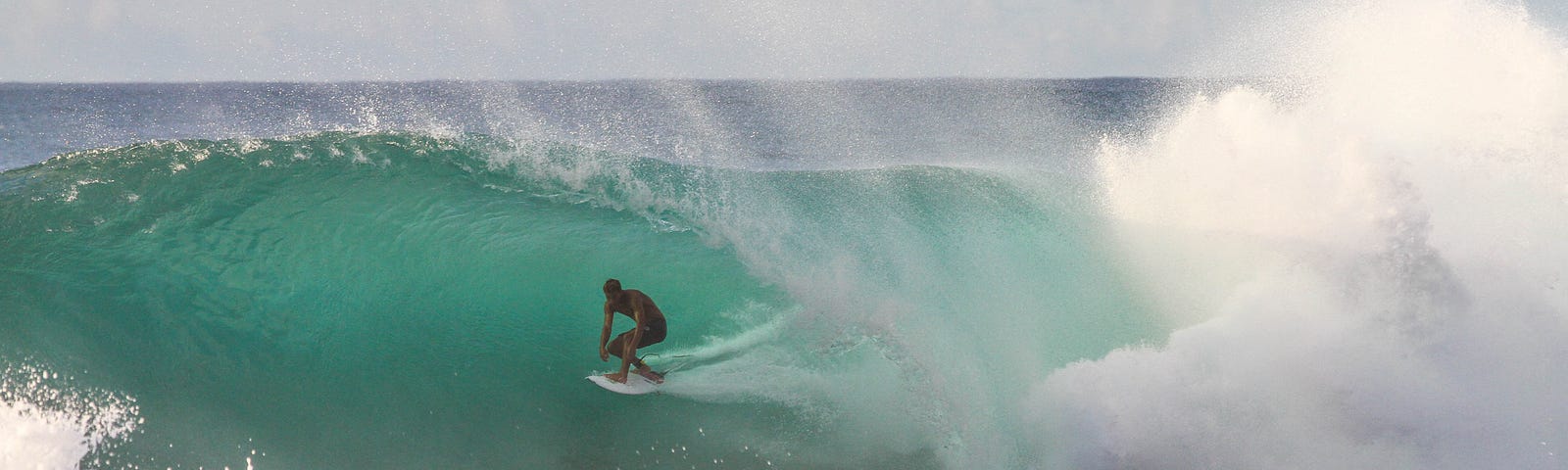 Surfer riding a big, warm water wave