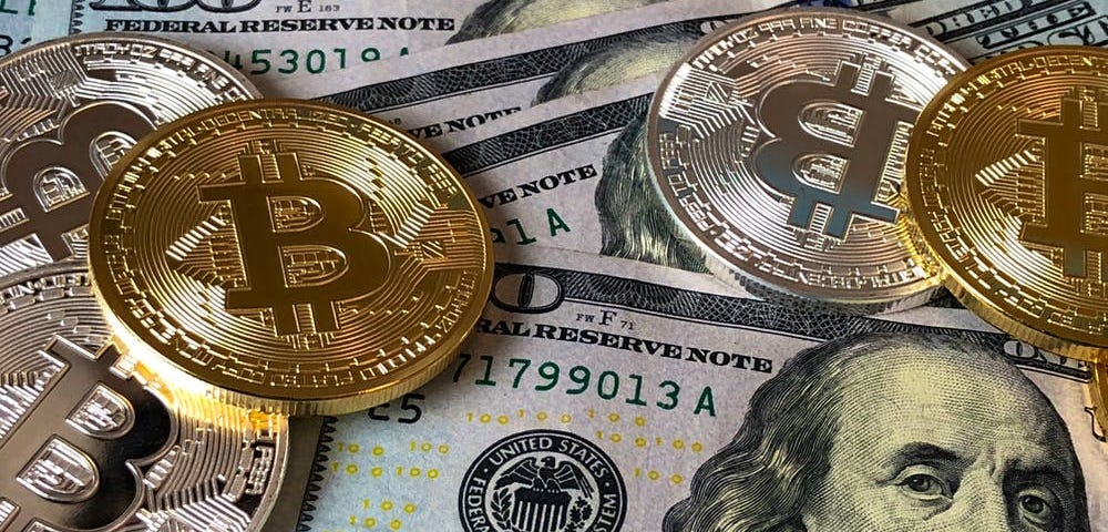 Bitcoin and US dollar bills