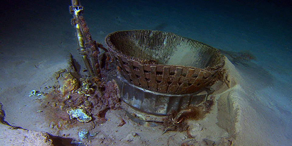 The Saturn V F-1 engine sitting half-buried on the ocean floor