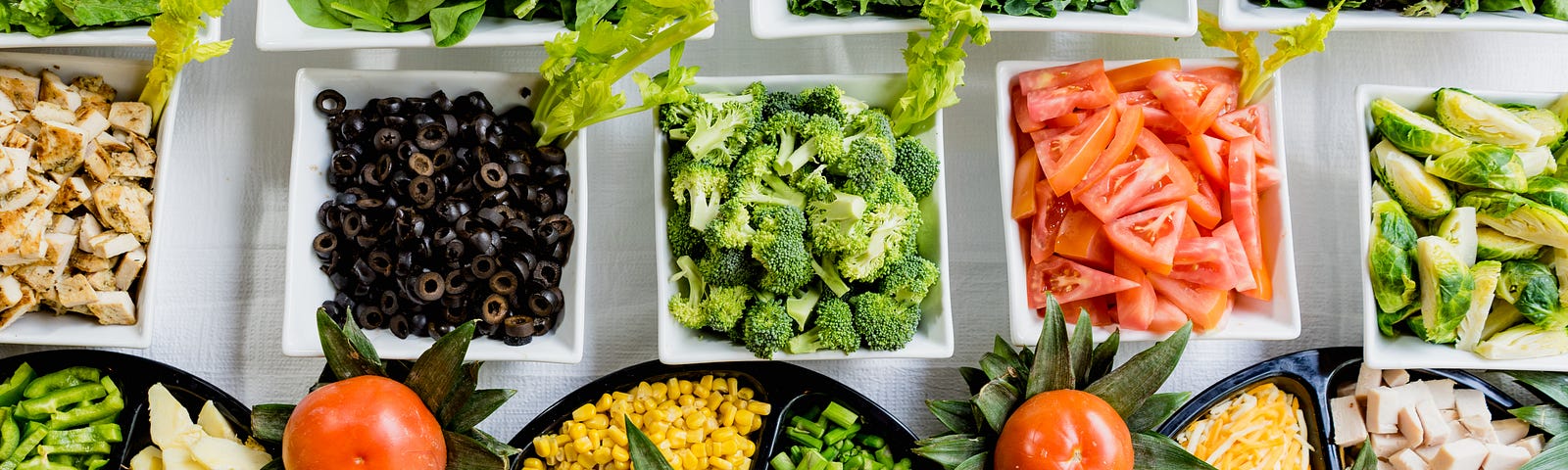 Numerous plates of fresh vegetables in assorted colors