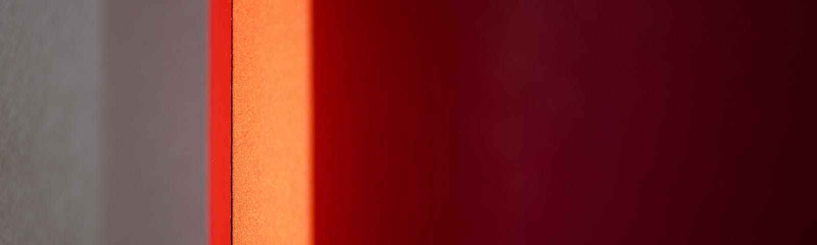 An abstract Rothko-esque image of gray, orange, and crimson