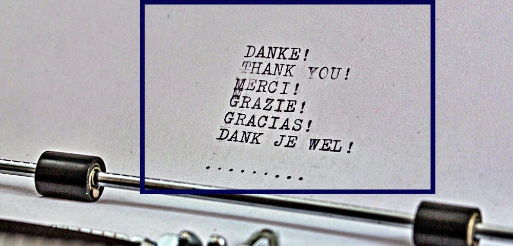 Paper coming out of a typewriter on which the word thank you has been typed in various languages