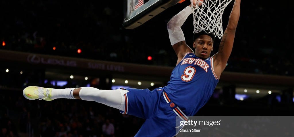 NBA player R.J Barrett of the New York Knicks hanging from the rim.