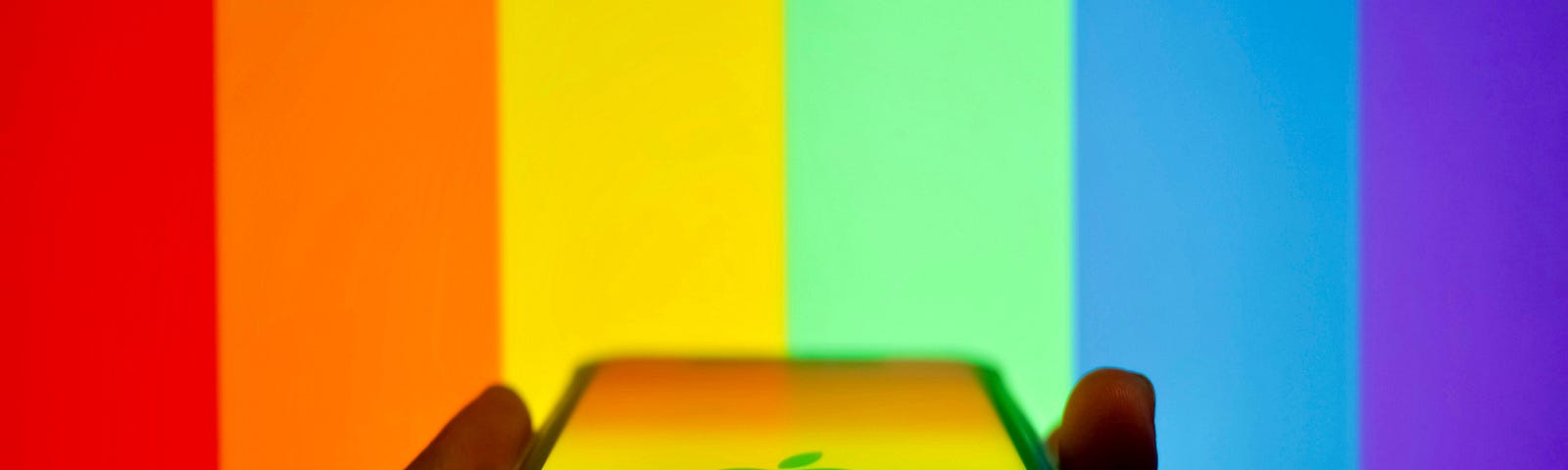 An iphone with a rainbow background