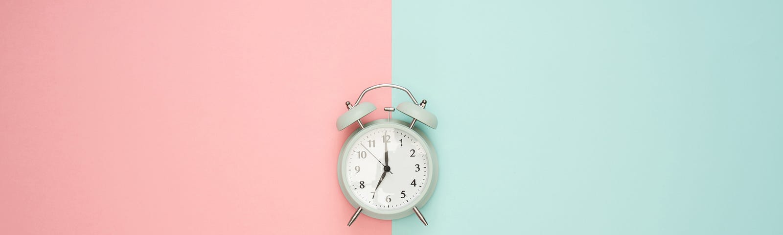 a clock on a pink and blue background
