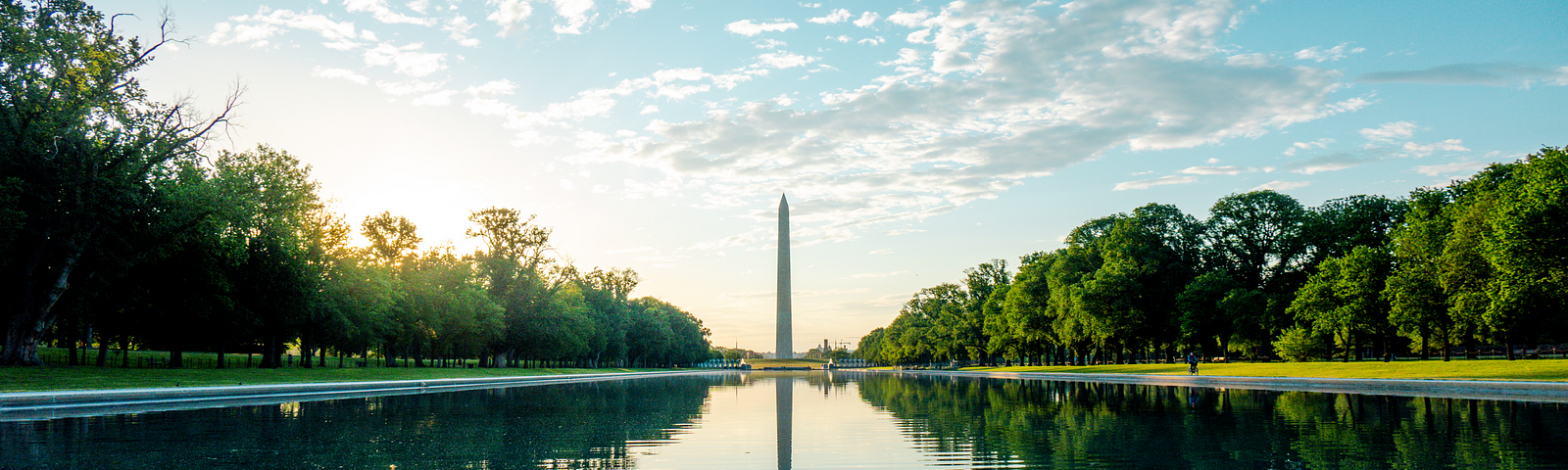 The bright calm  view of the Washington Monument at the end of the Lincoln Memorial reflecting pool on a peaceful day.
