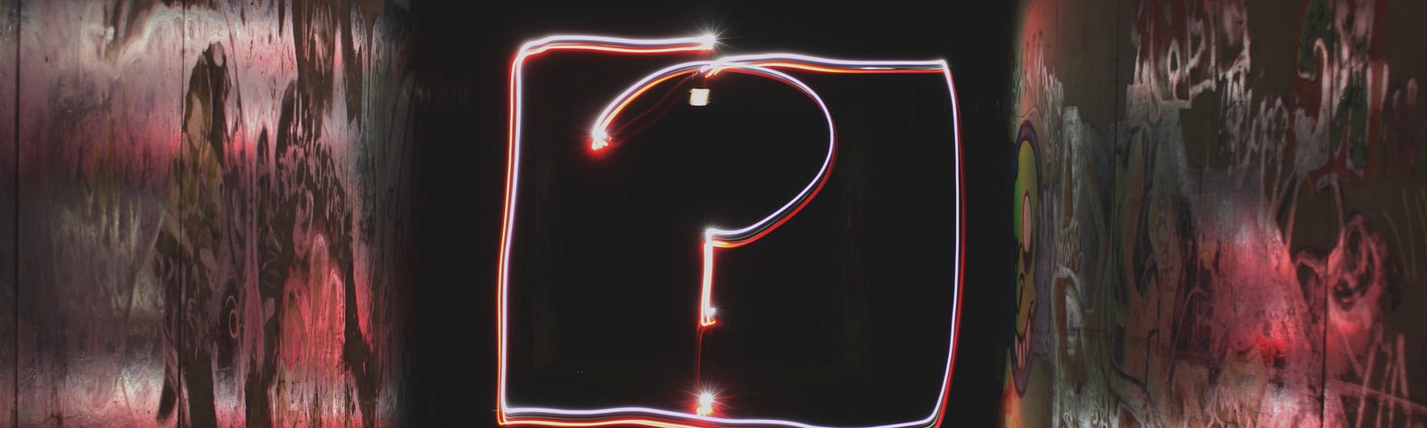 Giant neon question mark on a wall.
