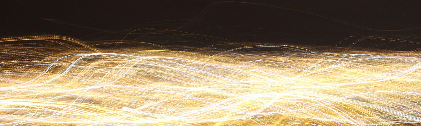 A “million” golden lines of light intertwined like wires against a black background.