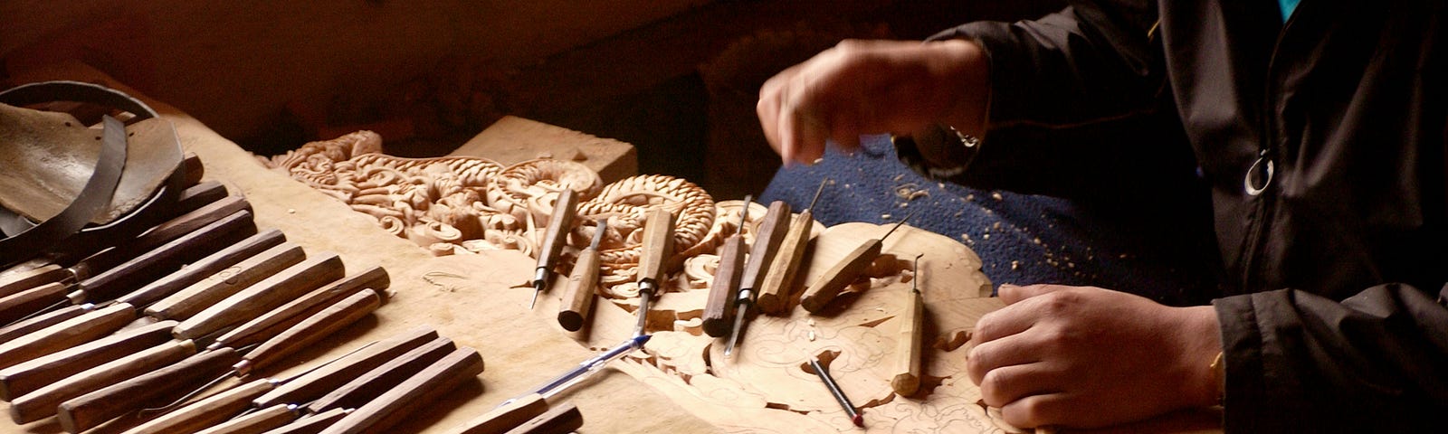 A woman working with different chisels.