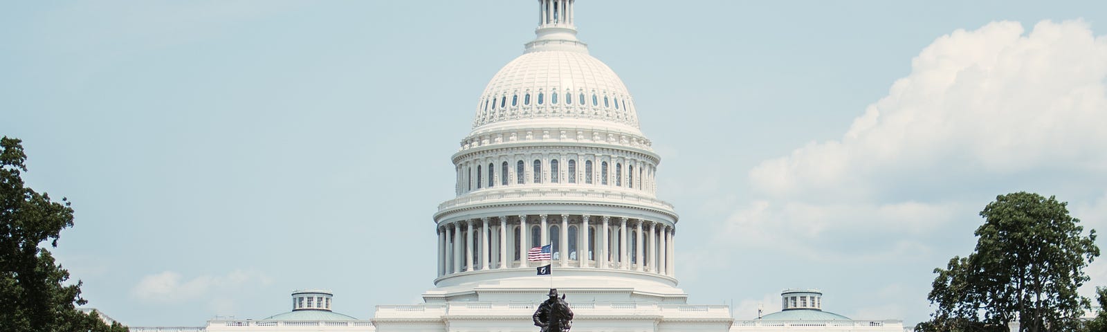 Photo of the U.S. Capitol with the reflecting pool in the foreground.