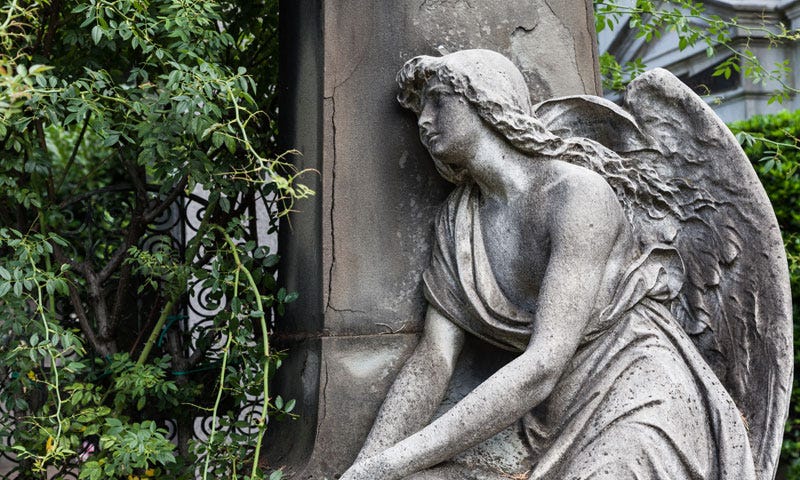 pensive angel at grave.