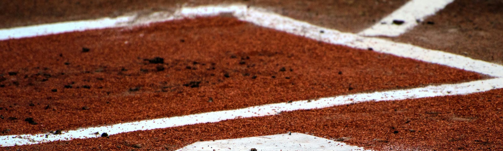 baseball home plate on reddish dirt