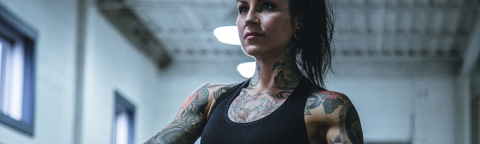 A heavily young woman (with lots of tattoos) exercises. A recent analysis discovered that strength training might be an effective, non-medication option to manage high blood pressure.