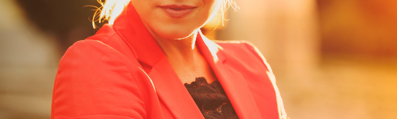 Woman in glaring light, red coat