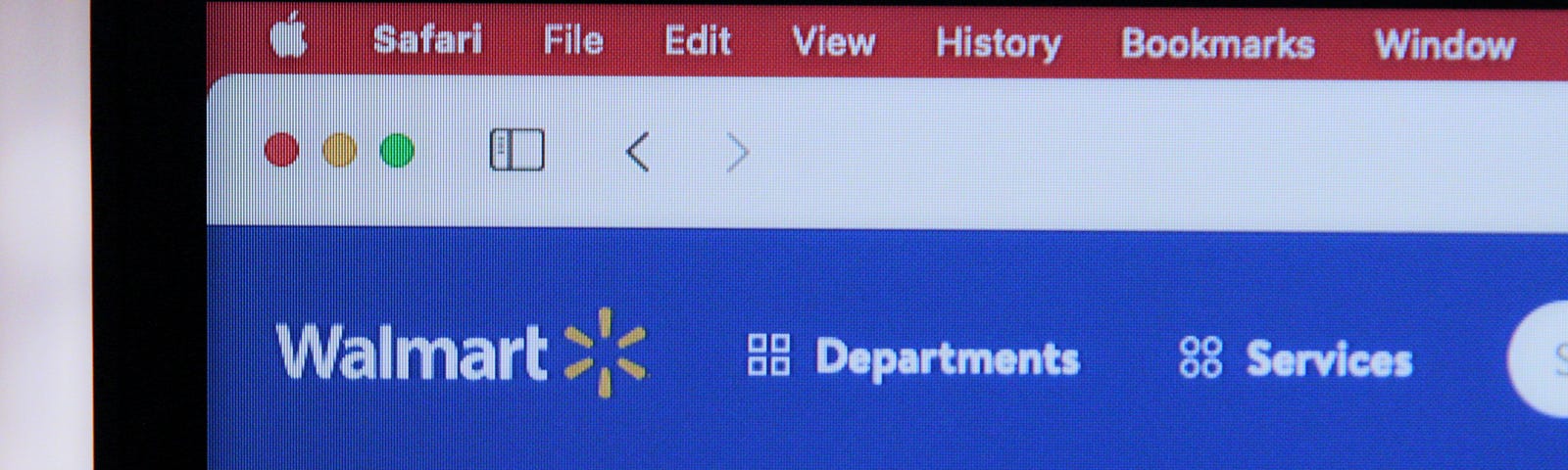 Close-up of the corner of a computer screen that shows the Safari web browser is open and the user is shopping on Walmart.com online marketplace