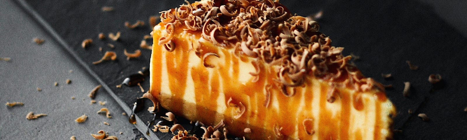 Cheesecake drizzled with caramel and chocolate shavings