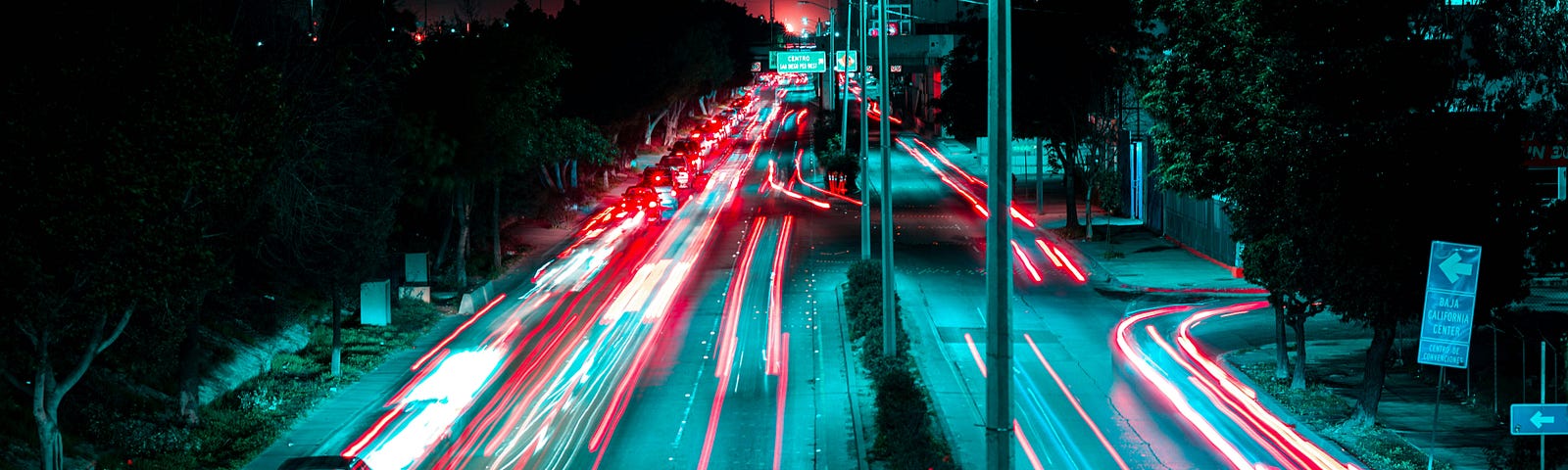 Cars driving down a Tijuana highway at night