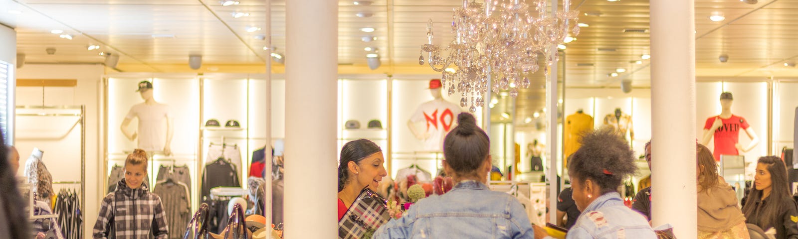 A receptionist is talking with the customers who wear blue jeans.