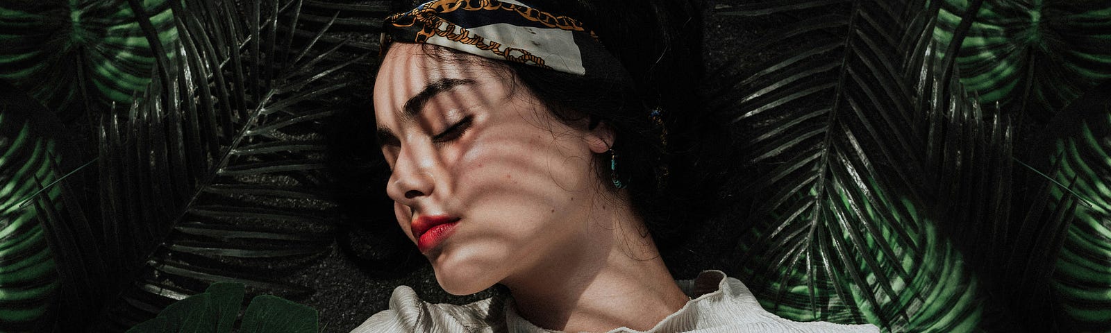 woman laying with shadows across her face