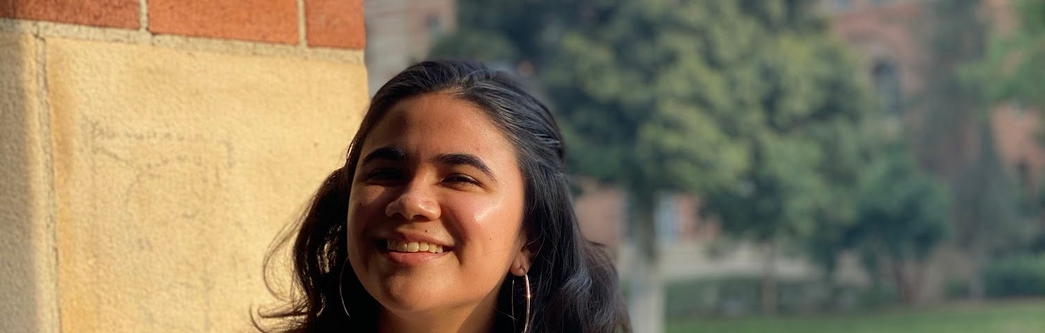 Image of Erica smiling with trees in the background