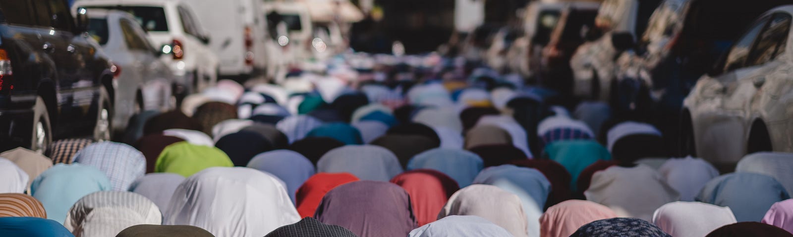 Muslims praying in a city.