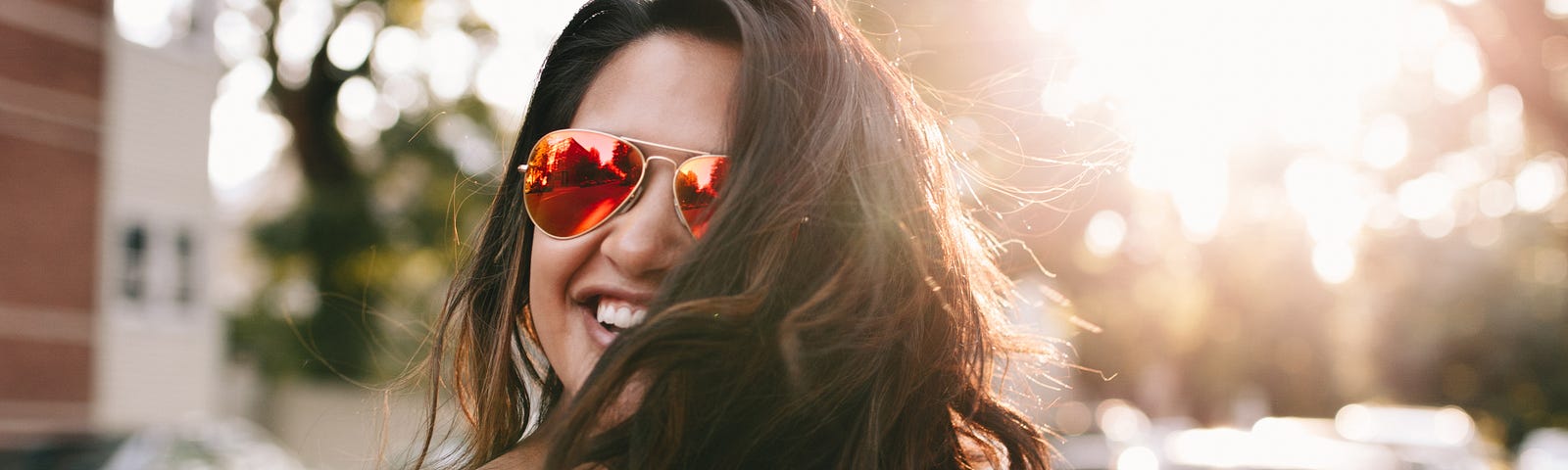 Woman smiling in the sunlight.