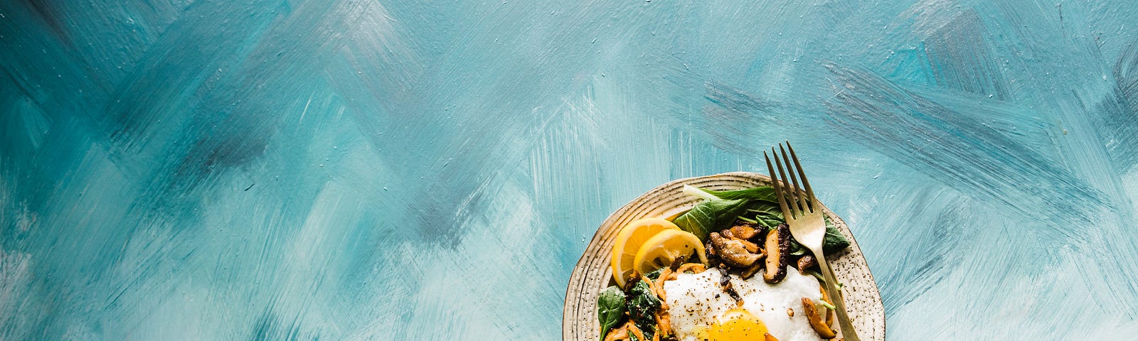 A plate of healthy noodles and vegetables is in the lower right corner of the image. A roughly painted background of broad blue and white streaks. Mindful eating is an ancient practice garnering considerable attention due to its potential to transform our relationship with food.