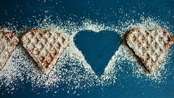 Heart shaped cookies garnished with sugar powder.