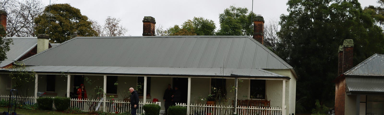 Picture of a house on a flooded street with the water going through the first floor.