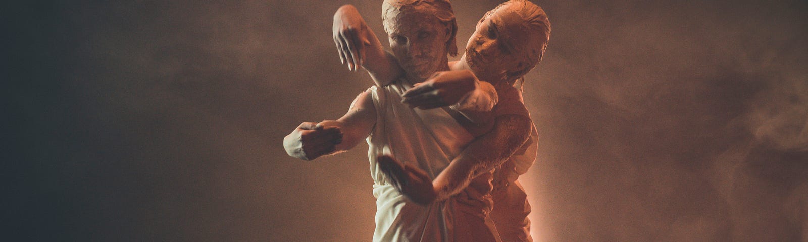 An usual image featuring two women interlinked from a live performance