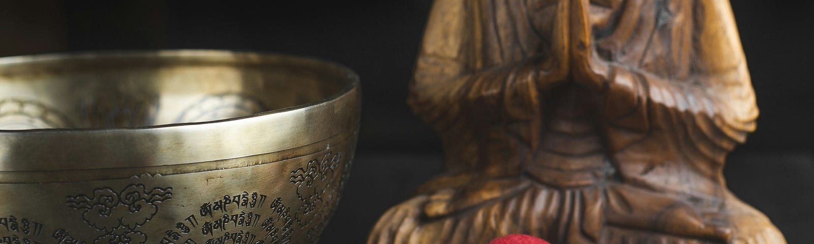 Spiritual items, a Buddha statue, and a singing bowl.