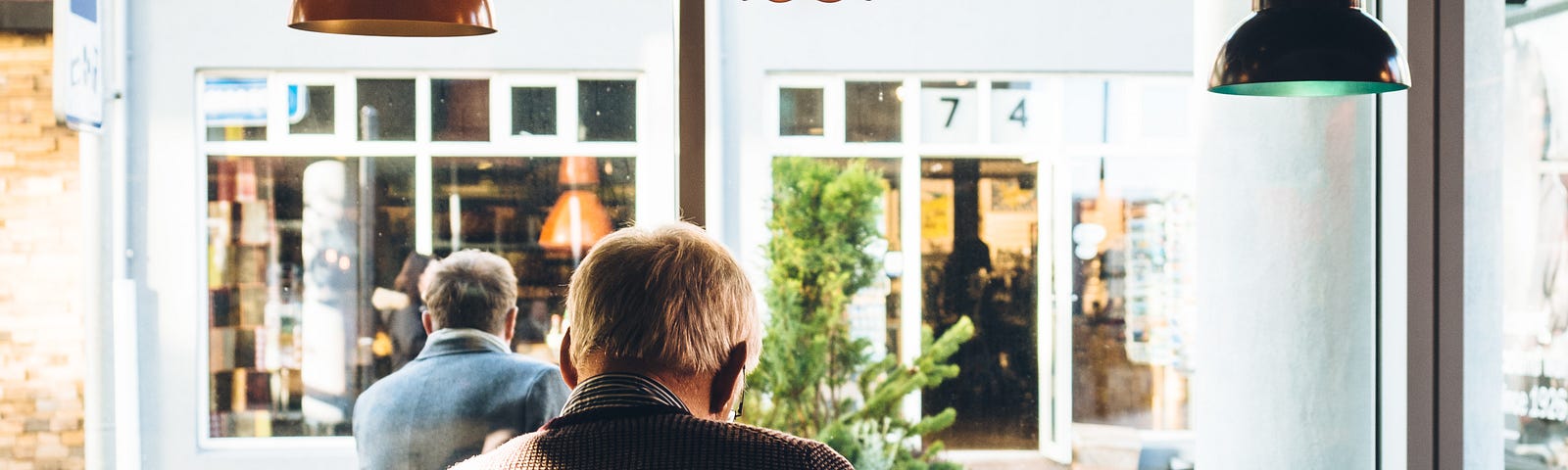 A senior sitting in a cafe.