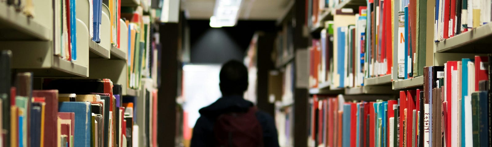 Image of a student walking through a school library