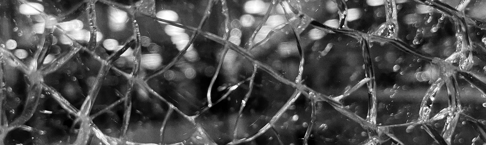 A shattered window in black and white.