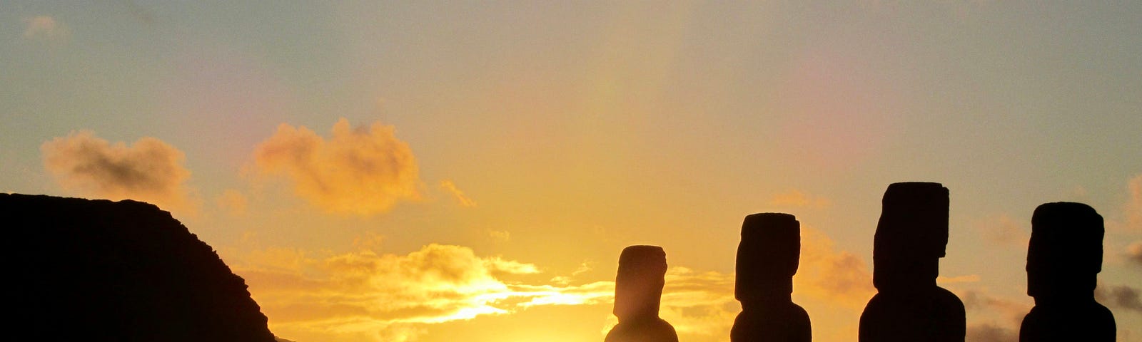 A sunset picture of the large statues on Easter Island