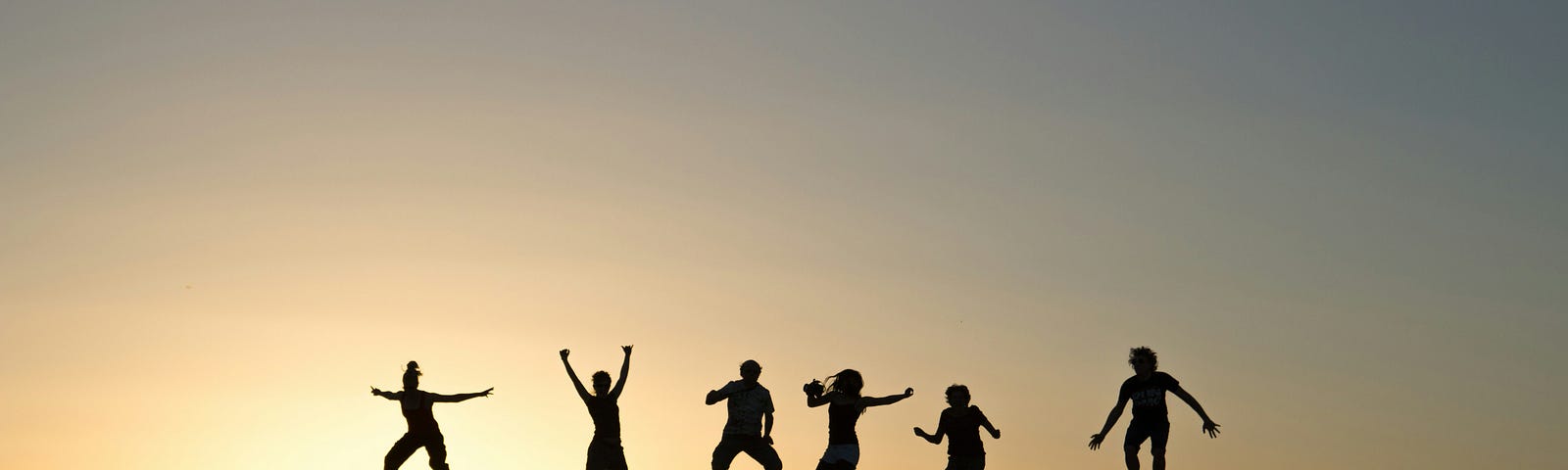 Jumping people silhouetted