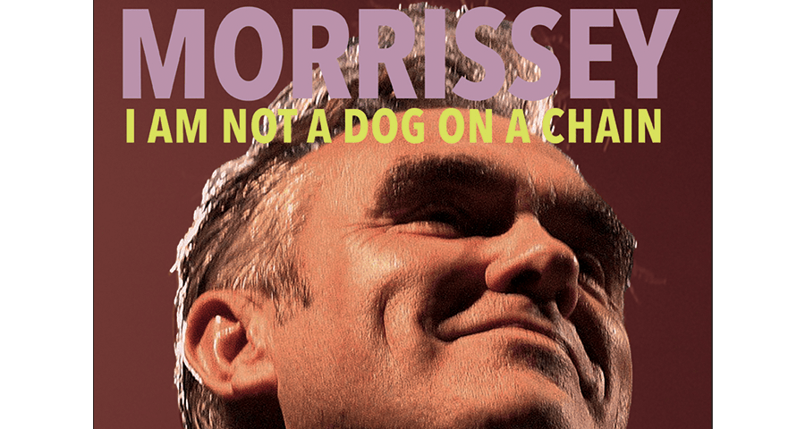 Morrissey “I Am Not A Dog On A Chain” album cover art; Morrissey from low camera perspective smiling facing top right, artist name in purple caps at top and album name in yellow caps underneath