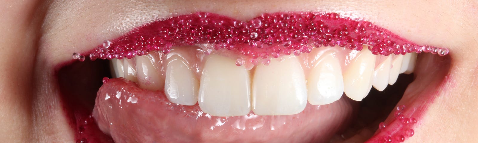 pink sparkly lipstick on just a mouth with a tongue to the side